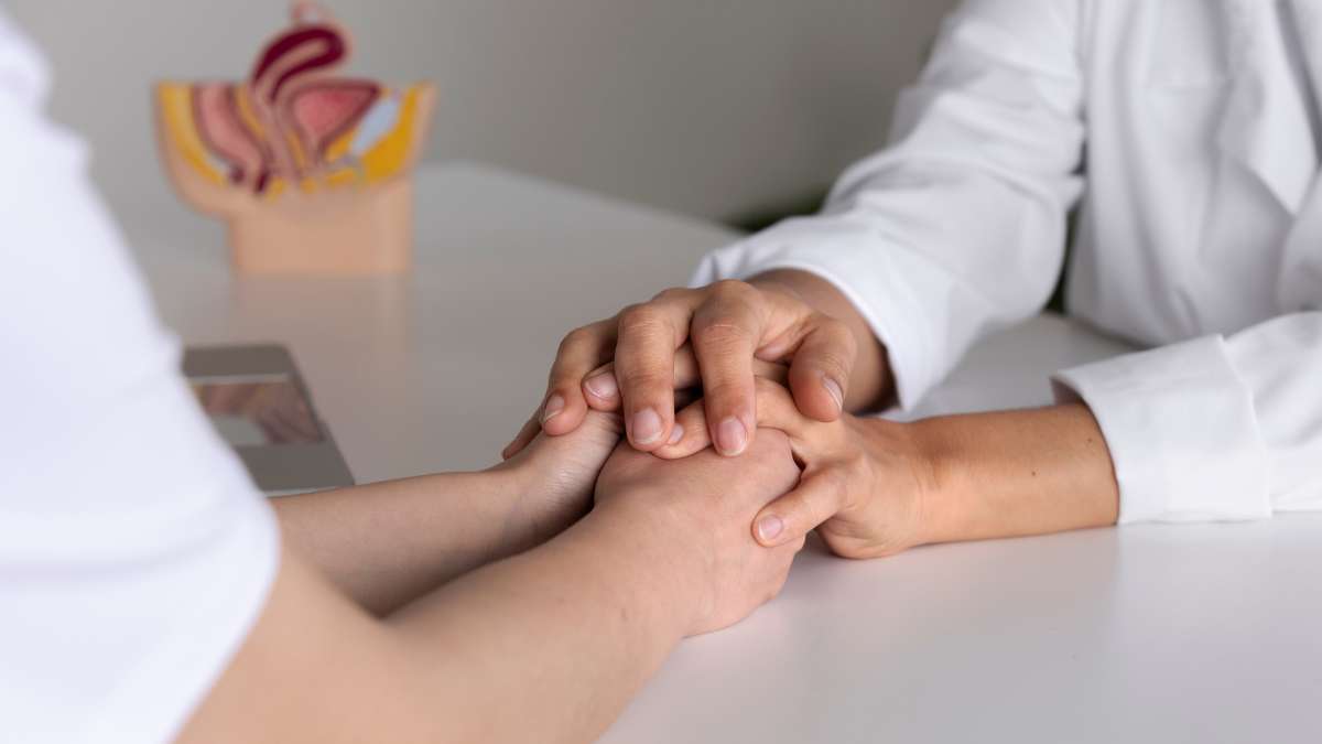 Therapist holding patient's hands during residential treatment program.