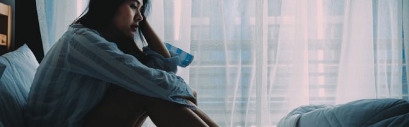 depressed-girl-on-bed Symptoms of Trauma